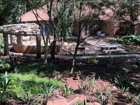 The cottage and braai area among the garden trees