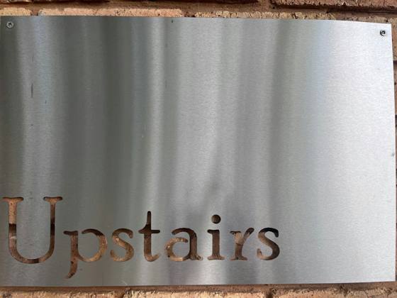 The Upstairs sign